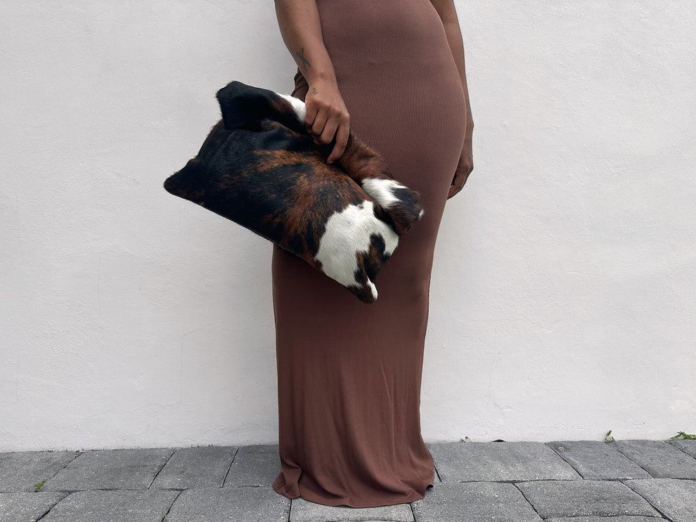 Three-tone cow print calfskin rolled edge clutch