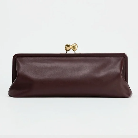 Elongated metal trim leather clutch bag