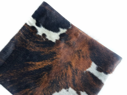 Three-tone cow print calfskin rolled edge clutch
