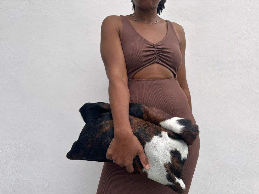Three-tone cow print calfskin rolled edge clutch